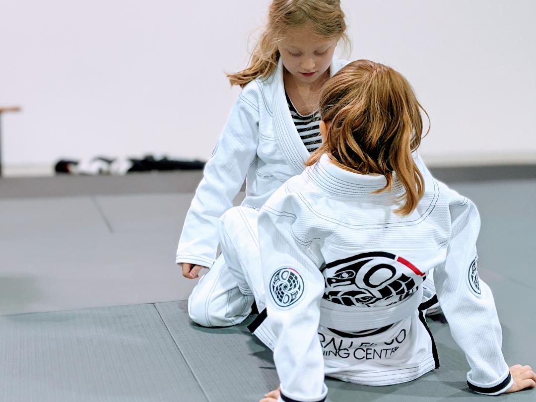 Kids practicing Brazilian Jiu Jitsu technique